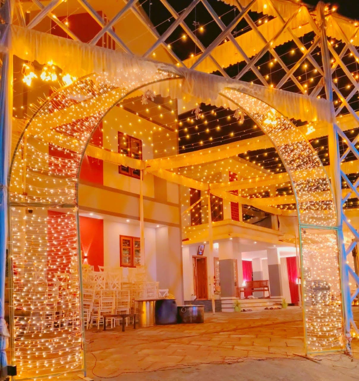 Courtyard archway wrapped in warm string lights at night